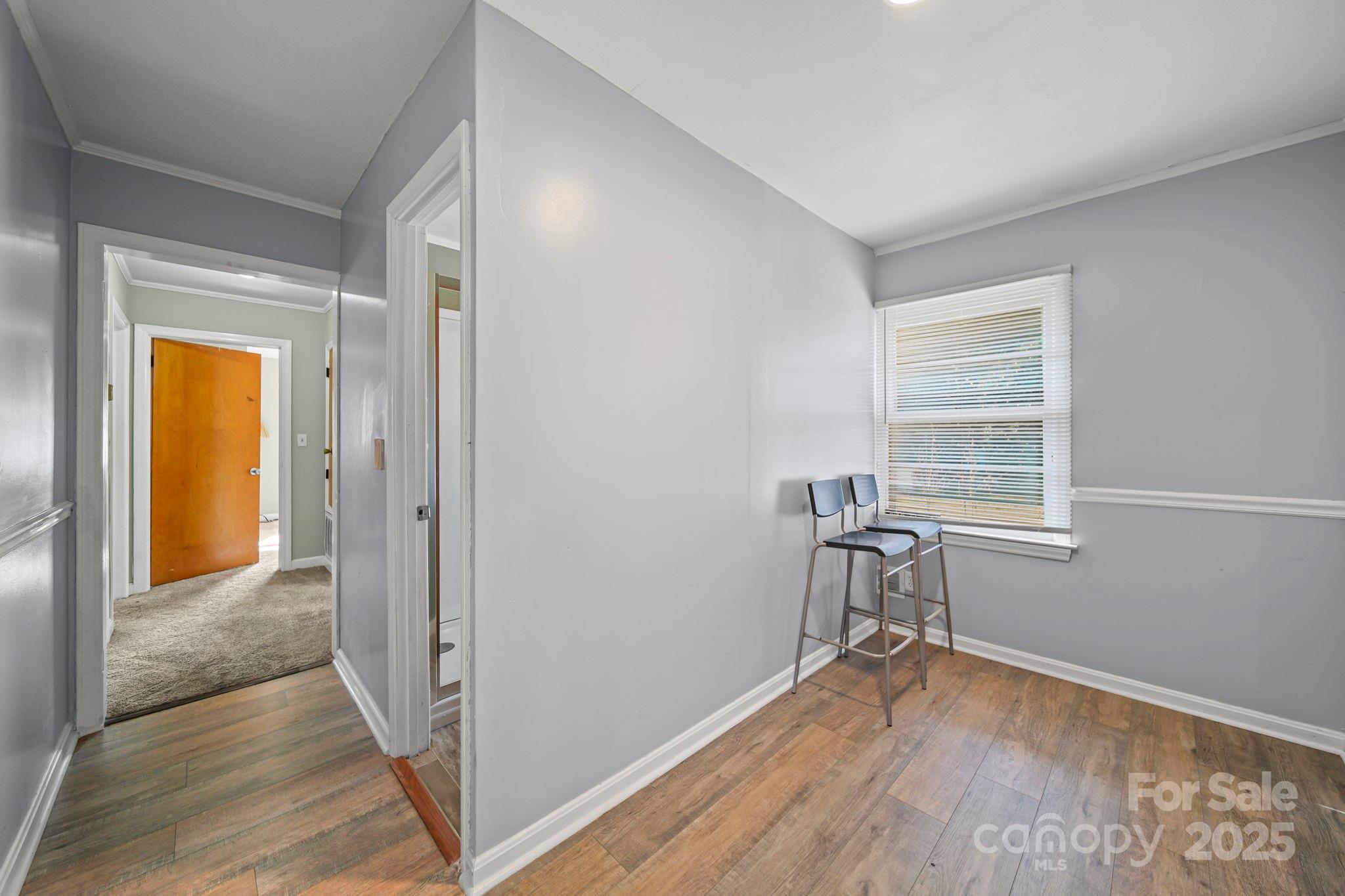 1703 East Perry Street Gastonia, NC 28054 - Photo 10 of 30 a view of empty room with wooden floor and fan
