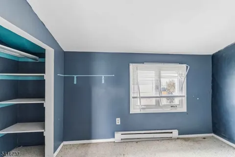 a view of a livingroom with an empty space and a window
