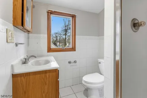 a bathroom with a sink toilet and a mirror