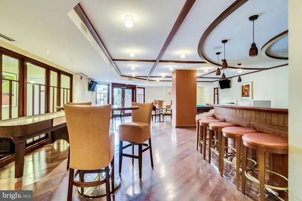 a dining room with furniture window and wooden floor