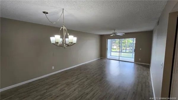 a view of wooden floor and windows in a room