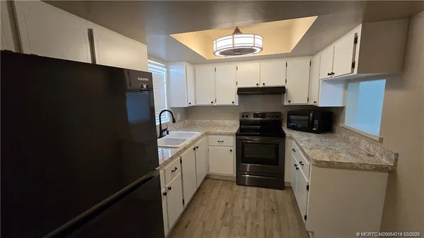 a kitchen with a sink a stove and refrigerator