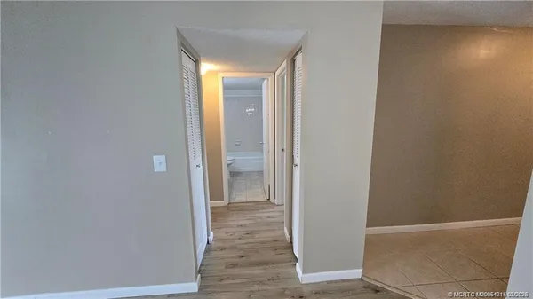 a view of a hallway with wooden floor