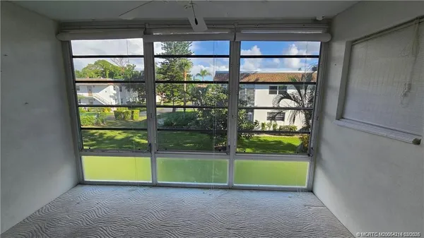a view of a room that has a bed and a window