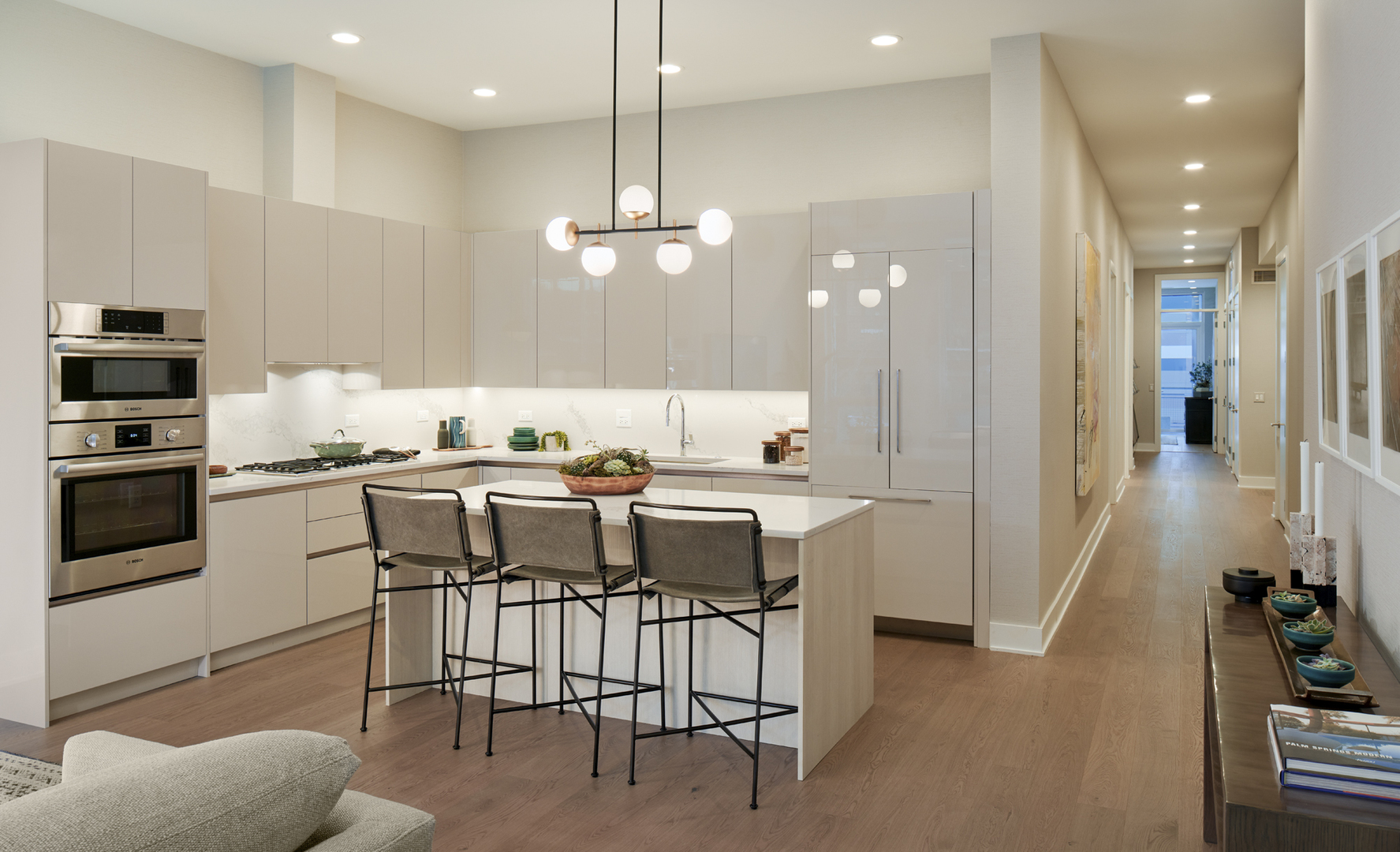 128 South Aberdeen Street, Unit 3S Chicago, IL 60607 - Photo 4 of 9 a kitchen with stainless steel appliances kitchen island granite countertop a stove a sink a refrigerator and a dining table with wooden floor