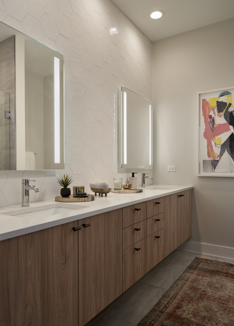 128 South Aberdeen Street, Unit 3S Chicago, IL 60607 - Photo 7 of 9 a bathroom with double vanity sinks and a mirror