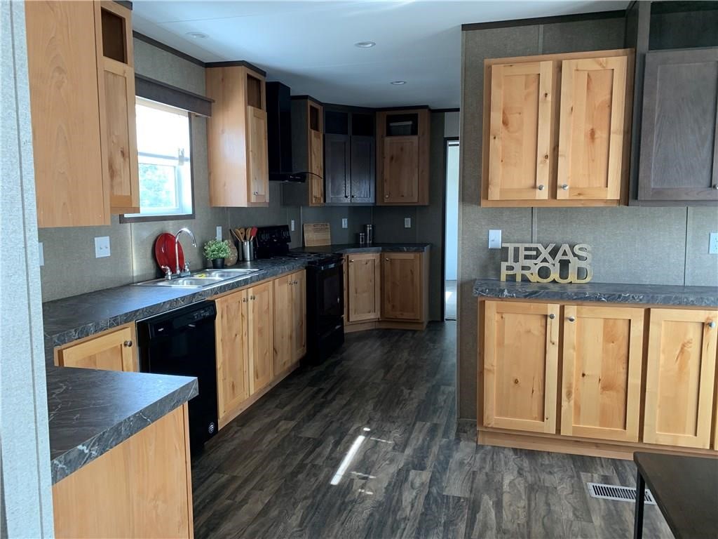 2550 FM 972 Georgetown, TX 78626 - Photo 24 of 29 a kitchen with wooden floors and sink