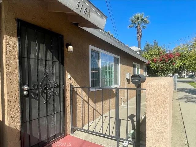 a view of a house with a small yard and floor to ceiling window
