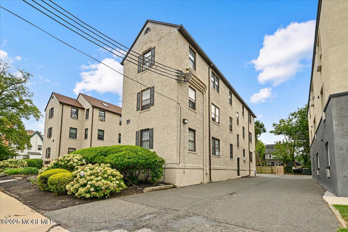 17 Leroy Place, Unit 3B Red Bank, NJ 07701 - Photo 5 of 36 a view of a white building among the street with a building