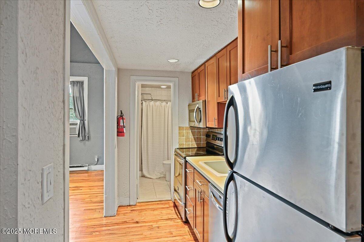 17 Leroy Place, Unit 3B Red Bank, NJ 07701 - Photo 7 of 36 a view of a kitchen from the stairs