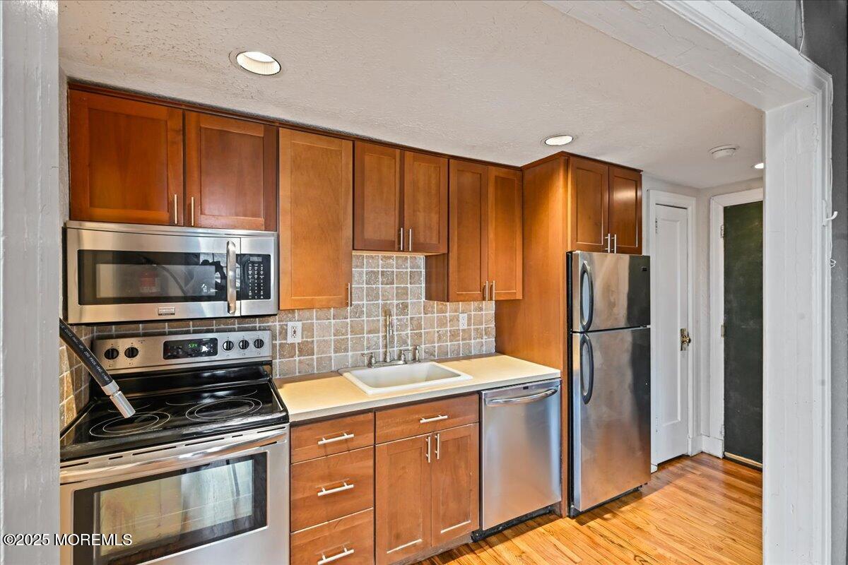 17 Leroy Place, Unit 3B Red Bank, NJ 07701 - Photo 8 of 36 a kitchen with stainless steel appliances a stove a sink and a refrigerator