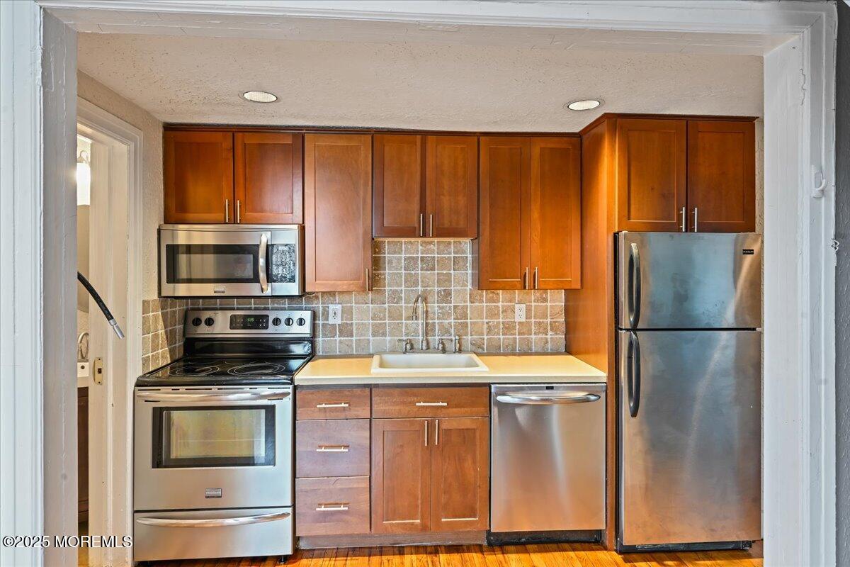 17 Leroy Place, Unit 3B Red Bank, NJ 07701 - Photo 10 of 36 a kitchen with stainless steel appliances a refrigerator and a stove top oven