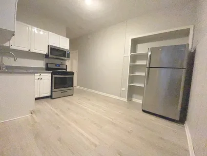 a view of a kitchen with electric appliances