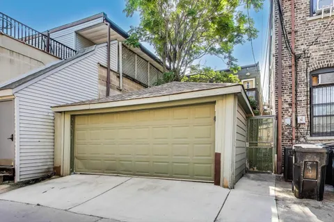 a view of a small house with a garage
