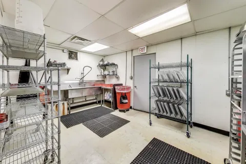 a view of a room with lots of wooden furniture