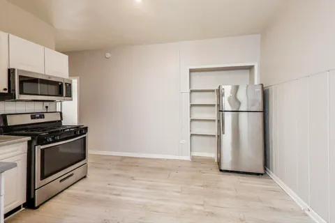 a kitchen with a stove and a refrigerator