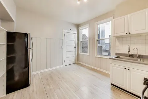 a kitchen with stainless steel appliances a refrigerator sink and cabinets