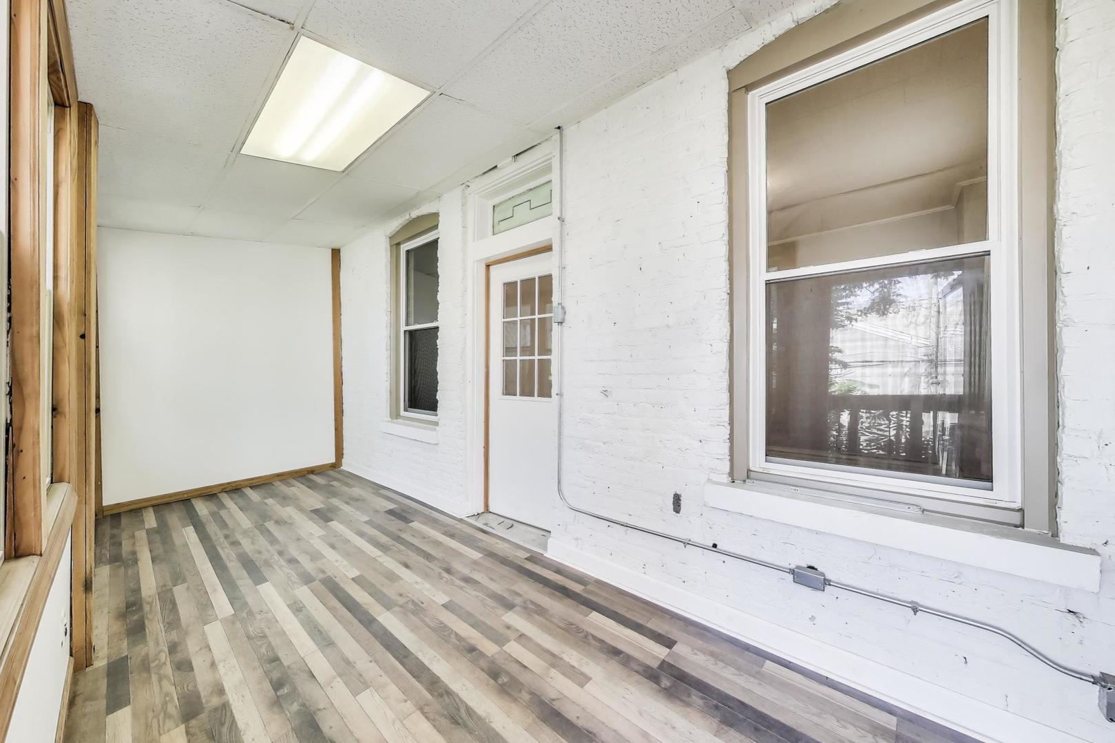 2889 North Milwaukee Avenue Chicago, IL 60618 - Photo 9 of 17 a view of a livingroom with wooden floor and a window