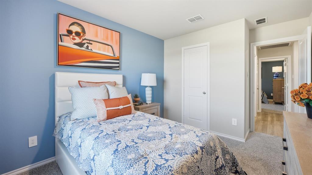 1616 Tin Roof Road Krum, TX 76249 - Photo 20 of 35 a bedroom with a bed and a painting on the wall