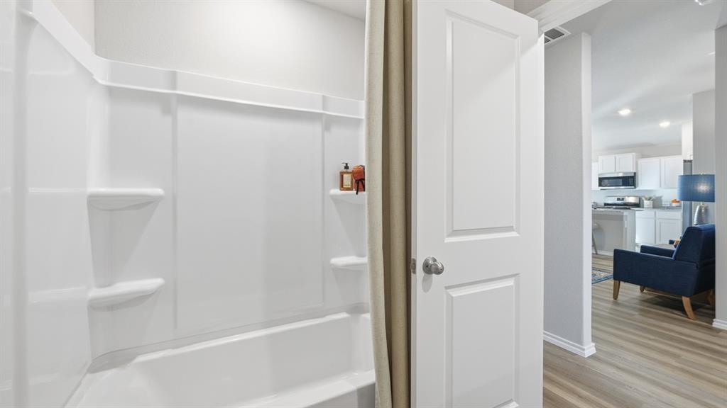 1616 Tin Roof Road Krum, TX 76249 - Photo 24 of 35 a bathroom with a bathtub and a shower