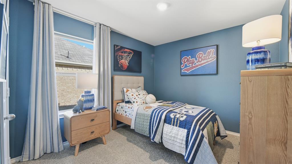 1616 Tin Roof Road Krum, TX 76249 - Photo 25 of 35 a bedroom with a bed and a lamp on table