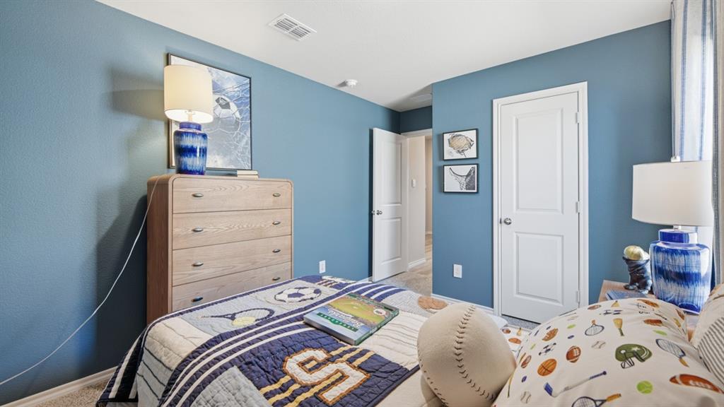 1616 Tin Roof Road Krum, TX 76249 - Photo 28 of 35 a bedroom with a bed and a lamp