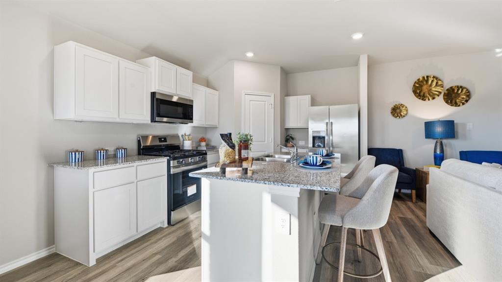 a kitchen with a dining table chairs and a stove top oven