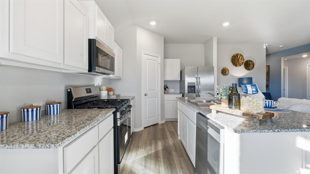 1616 Tin Roof Road Krum, TX 76249 - Photo 2 of 35 a kitchen with stainless steel appliances granite countertop a sink stove and refrigerator