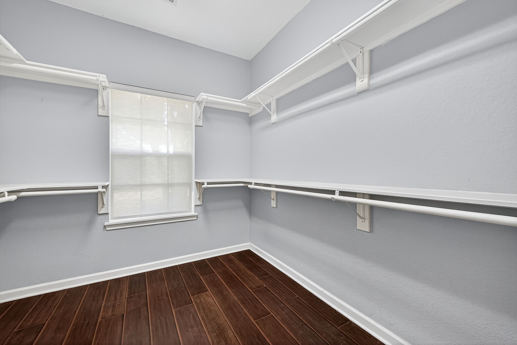 22406 Piper Terrace Lane Katy, TX 77450 - Photo 32 of 44 a view of an empty room with wooden floor and a window