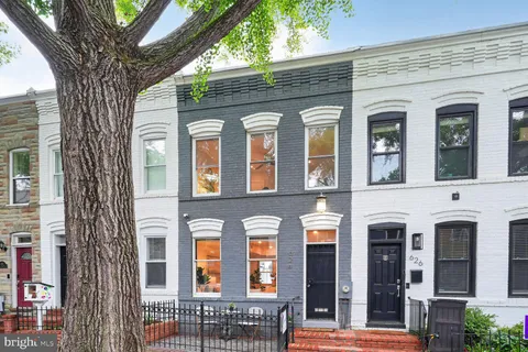 front view of a brick house with large windows
