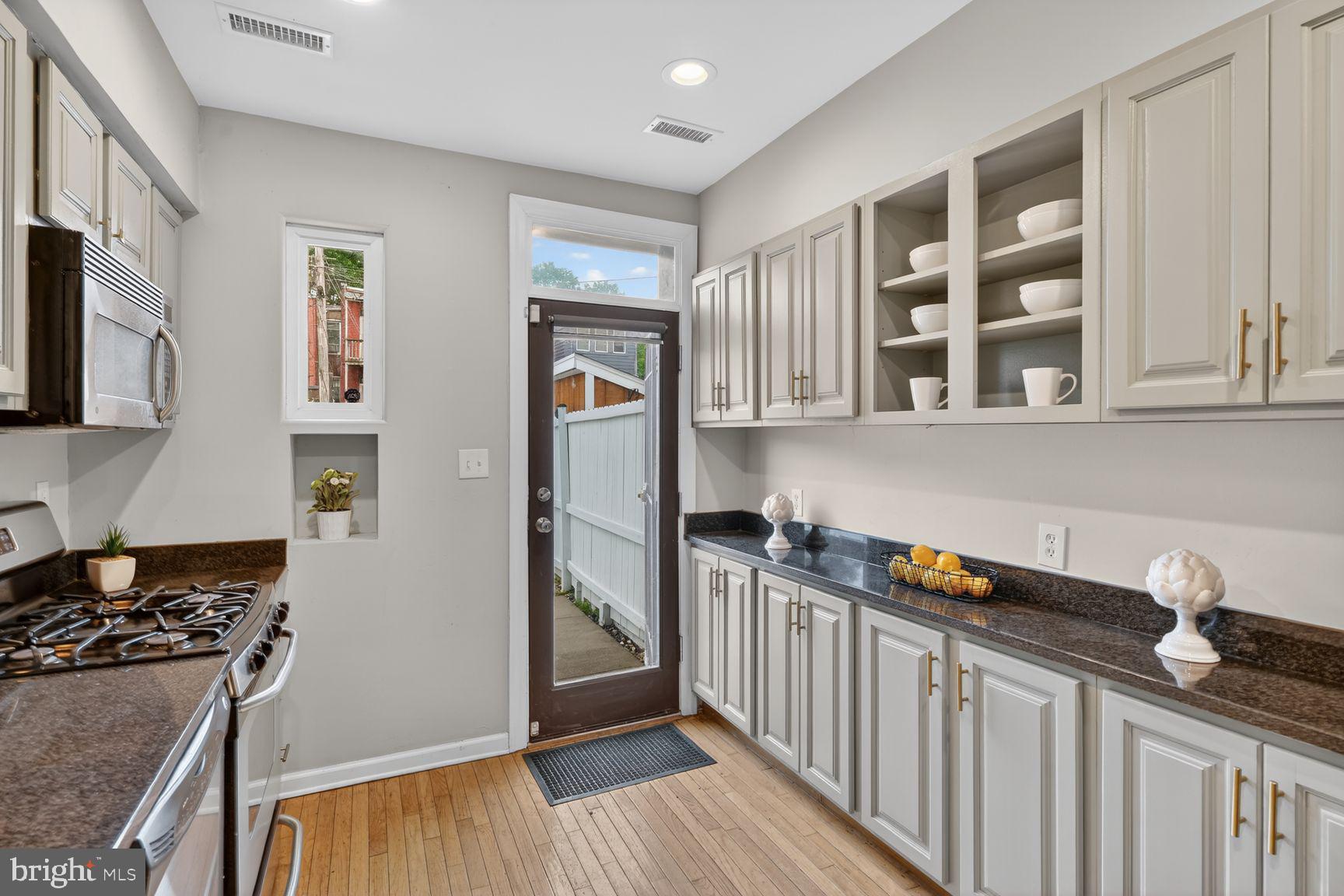 624 14th Place Northeast Washington, DC 20002 - Photo 12 of 25 a kitchen with stainless steel appliances granite countertop a stove and a refrigerator