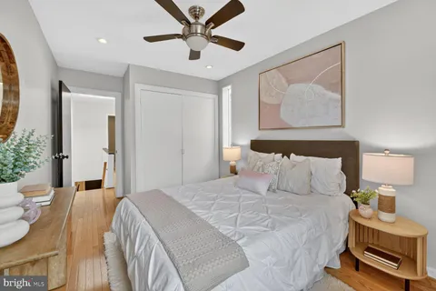 a bedroom with a bed and a painting on the wall