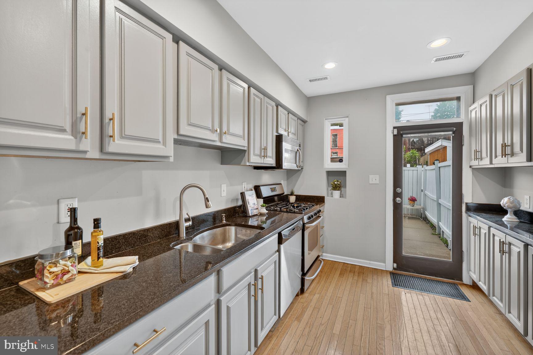 624 14th Place Northeast Washington, DC 20002 - Photo 9 of 25 a kitchen with stainless steel appliances granite countertop a sink stove and refrigerator