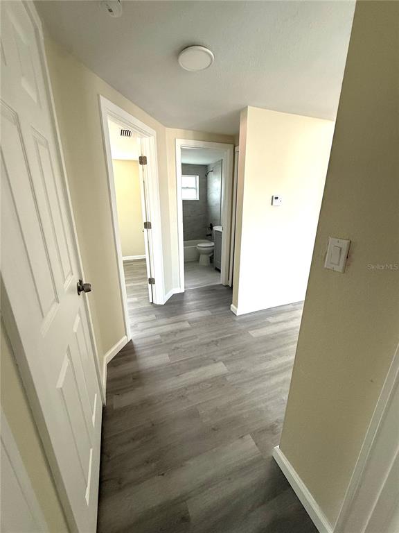 5318 Cedar Lane New Port Richey, FL 34652 - Photo 12 of 32 a view of a hallway with wooden floor and staircase