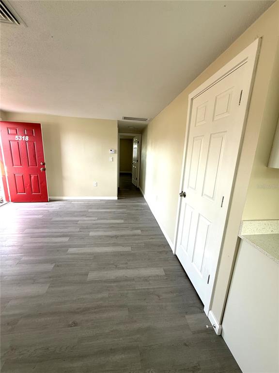 5318 Cedar Lane New Port Richey, FL 34652 - Photo 16 of 32 a view of a hallway with wooden floor