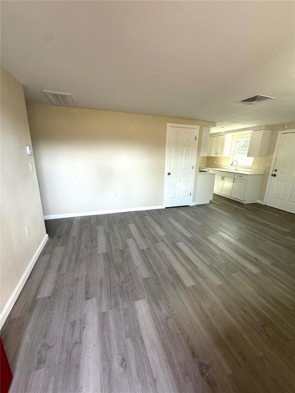 5318 Cedar Lane New Port Richey, FL 34652 - Photo 17 of 32 a view of a room with wooden floor and sink