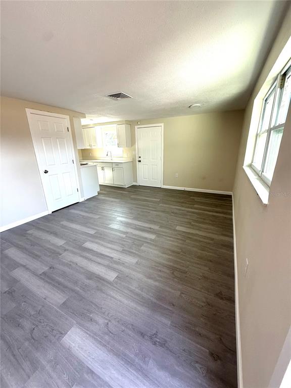 5318 Cedar Lane New Port Richey, FL 34652 - Photo 18 of 32 a view of a kitchen with wooden floor and a sink