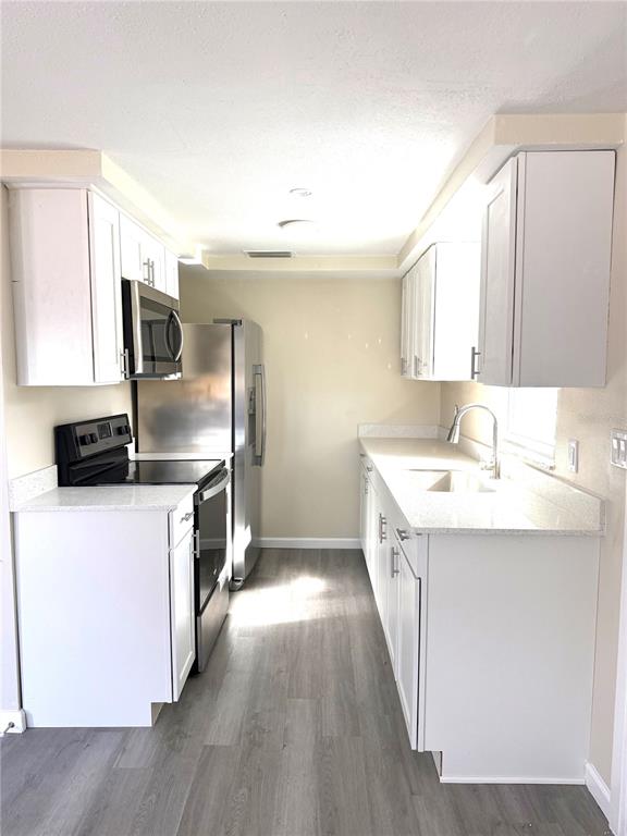 5318 Cedar Lane New Port Richey, FL 34652 - Photo 19 of 32 a kitchen with a sink stove and refrigerator