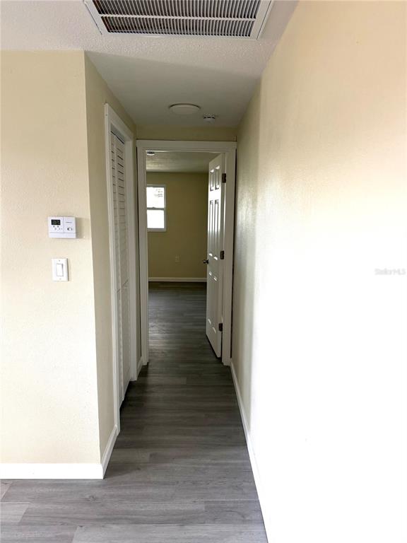 5318 Cedar Lane New Port Richey, FL 34652 - Photo 20 of 32 a view of a hallway with wooden floor