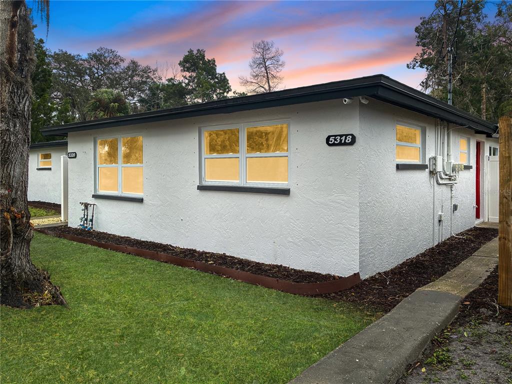 5318 Cedar Lane New Port Richey, FL 34652 - Photo 2 of 32 a front view of a house with garden