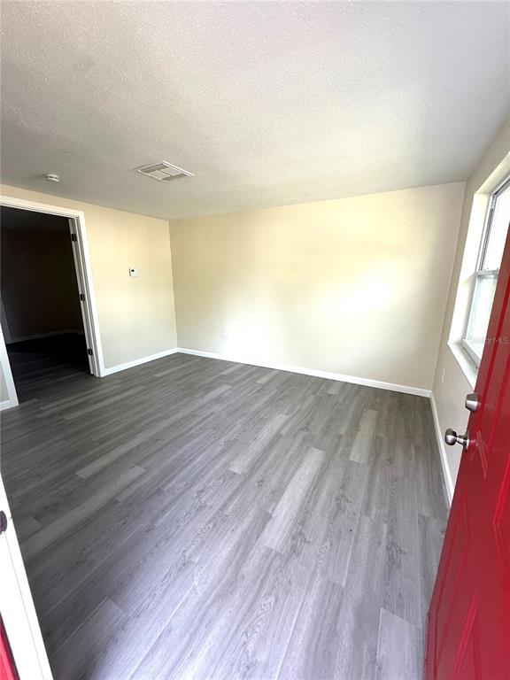 5318 Cedar Lane New Port Richey, FL 34652 - Photo 26 of 32 wooden floor in an empty room with a window