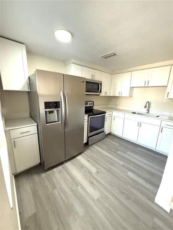 5318 Cedar Lane New Port Richey, FL 34652 - Photo 29 of 32 a kitchen with granite countertop a refrigerator and a sink