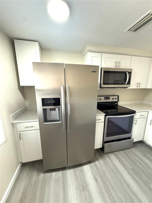 5318 Cedar Lane New Port Richey, FL 34652 - Photo 31 of 32 a kitchen with a refrigerator and a stove