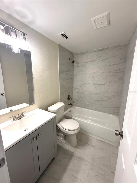 5318 Cedar Lane New Port Richey, FL 34652 - Photo 32 of 32 a bathroom with a sink a toilet and shower