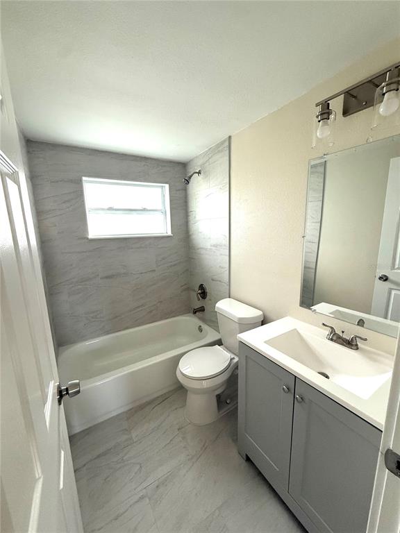 5318 Cedar Lane New Port Richey, FL 34652 - Photo 6 of 32 a bathroom with a double vanity sink toilet and shower