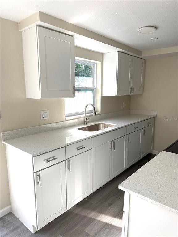 5318 Cedar Lane New Port Richey, FL 34652 - Photo 9 of 32 a kitchen with cabinets appliances a sink and a window