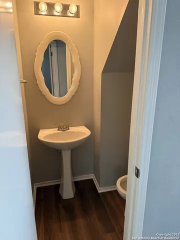 a bathroom with a sink toilet and a mirror