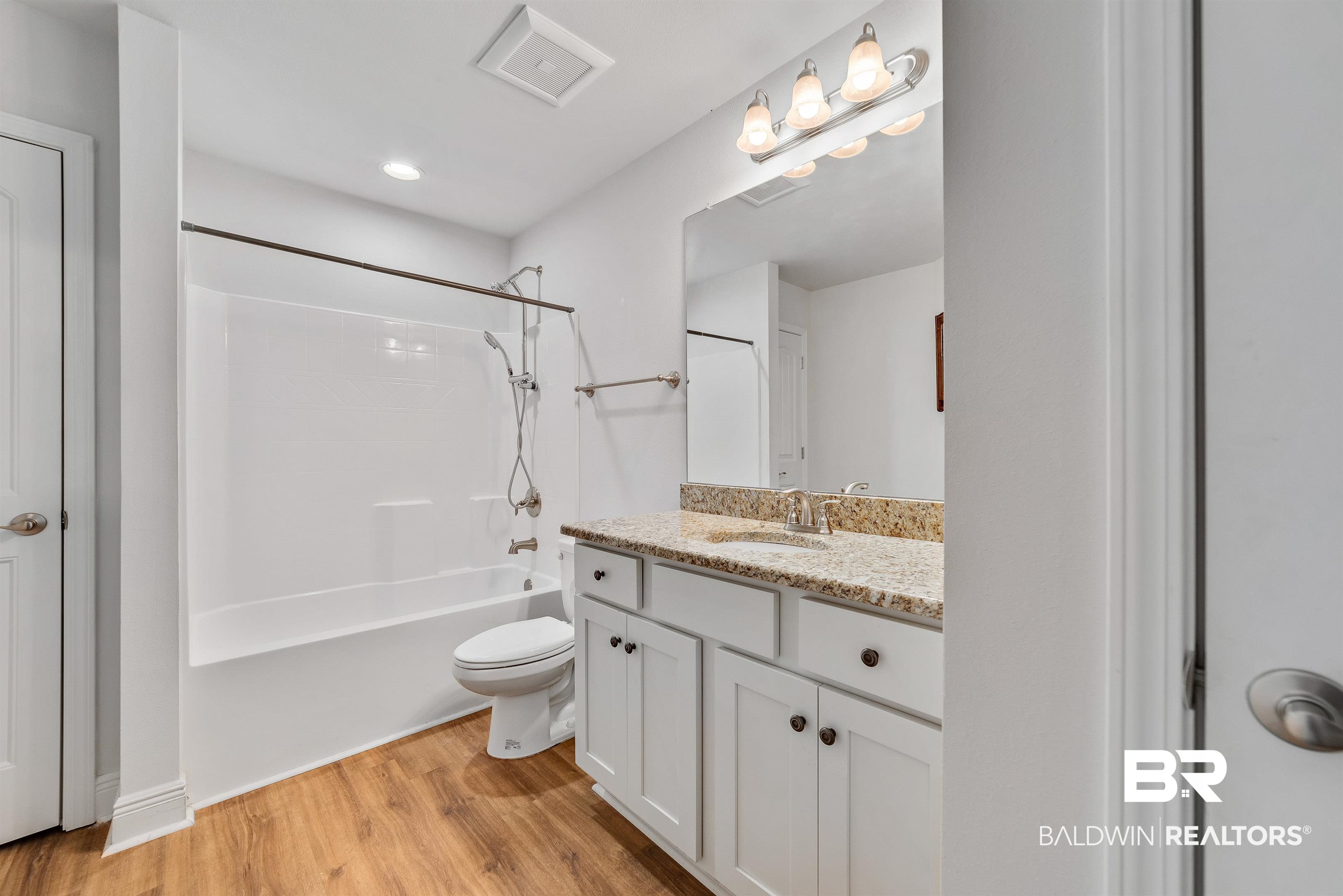 13155 Wishbone Court Foley, AL 36535 - Photo 26 of 39 Full bathroom featuring shower / bathtub combination, vanity, toilet, and hardwood / wood-style floors