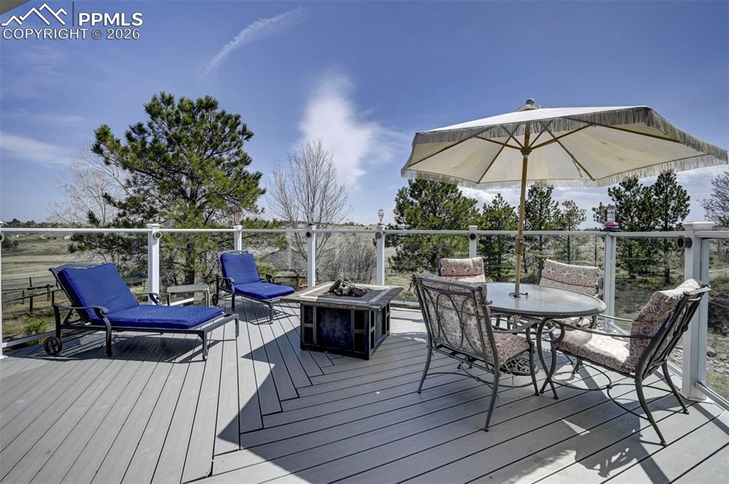 5910 McCart Ranch Circle Elizabeth, CO 80107 - Photo 11 of 50 a view of a roof deck with table and chairs