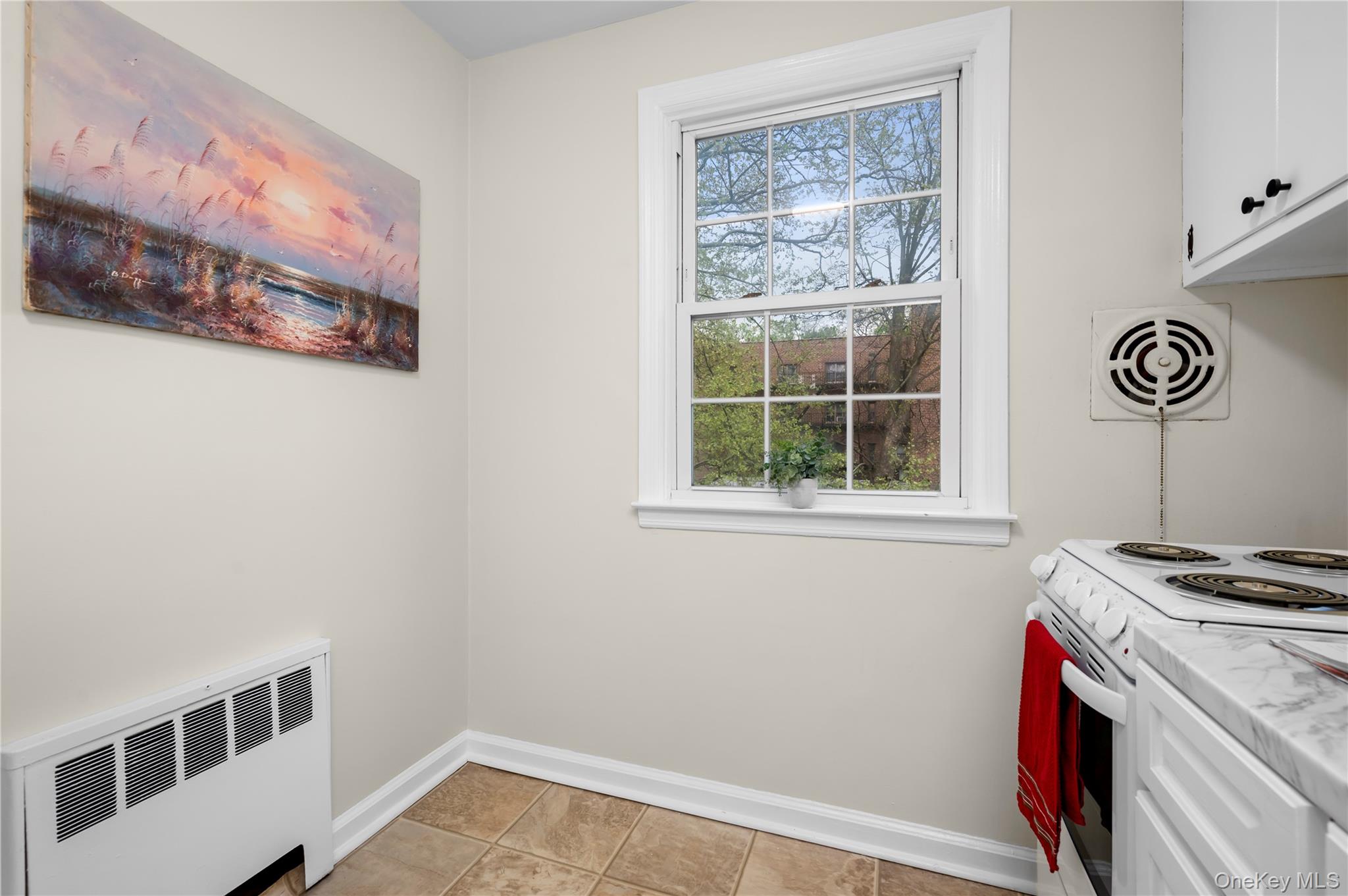 51 Cross Street, Unit 3B Yonkers, NY 10708 - Photo 3 of 18 Kitchen area featuring a large window with grid panes, white trim.